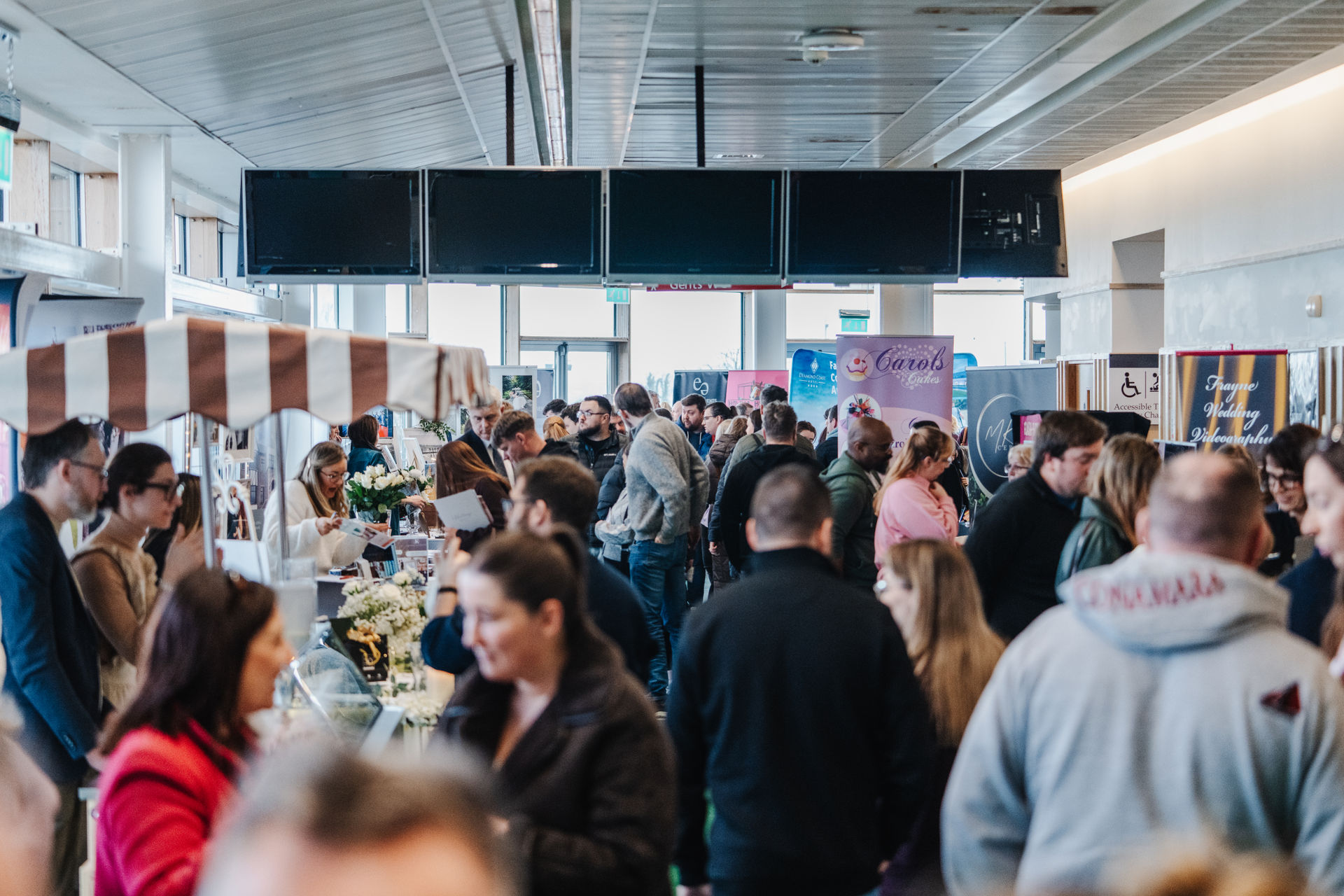 Busy crowd browsing supplier stands at Wedfest